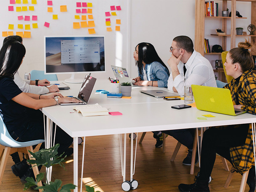 People in office space looking at computer screen