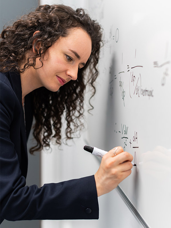 Woman writing on whiteboard